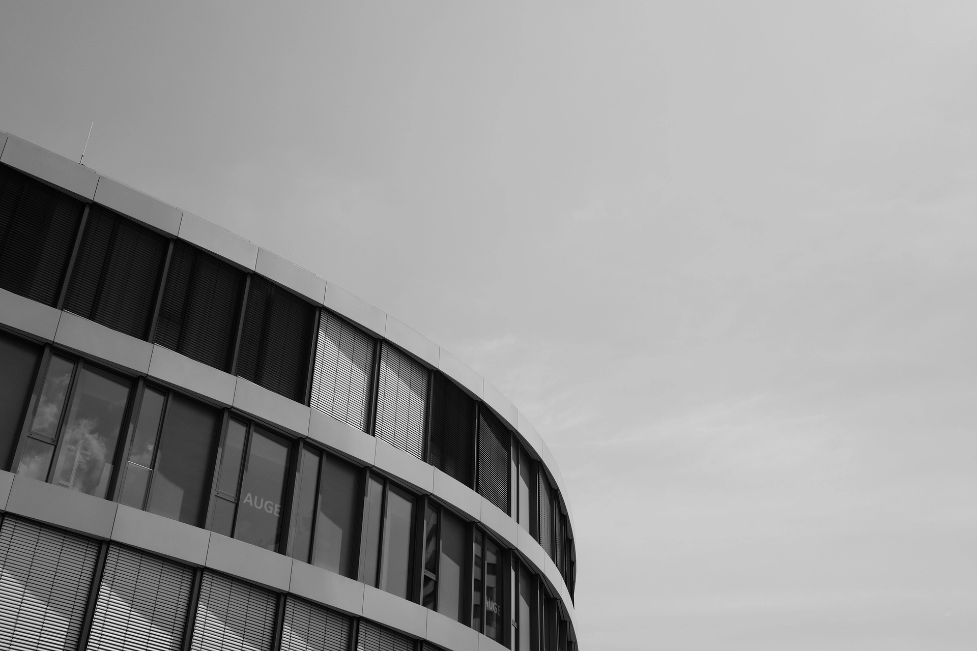 A modern curved building partly in the lower right. Otherwise only sky.